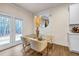 Bright dining area with glass table and modern chairs, offering natural light at 1087 Shadow Glen Dr, Fairburn, GA 30213