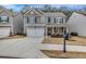 Two-story house with gray siding, white trim, and a two-car garage at 1087 Shadow Glen Dr, Fairburn, GA 30213