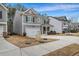 Gray two-story house in a neighborhood setting with a concrete driveway at 1087 Shadow Glen Dr, Fairburn, GA 30213