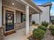 Inviting front porch with white columns and a charming door at 1087 Shadow Glen Dr, Fairburn, GA 30213