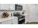 White kitchen with stainless steel appliances and subway tile backsplash at 1087 Shadow Glen Dr, Fairburn, GA 30213