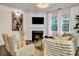 Cozy living room featuring a fireplace and ample natural light at 1087 Shadow Glen Dr, Fairburn, GA 30213