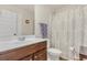 Clean bathroom with single sink vanity, shower/tub combo, and neutral decor at 11850 Markham Way, Hampton, GA 30228