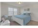 Bright bedroom with a queen bed, window seating and lots of natural light at 11850 Markham Way, Hampton, GA 30228