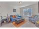 Charming bedroom with blue couch and arm chair. This room has hardwood floors and lots of natural light at 11850 Markham Way, Hampton, GA 30228