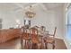 Bright dining room features hardwood floors, a chandelier, and a large wooden table with chairs at 11850 Markham Way, Hampton, GA 30228