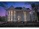 Evening view of a two story home with wrap around porch at 119 E Johnson E St, Temple, GA 30179