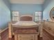 Main bedroom with light blue walls and large windows at 1734 Spring Hill Cv, Lithonia, GA 30058