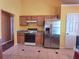 Kitchen boasts stainless steel appliances and wood cabinets at 1734 Spring Hill Cv, Lithonia, GA 30058