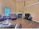 Living room with hardwood floors and a fireplace at 1734 Spring Hill Cv, Lithonia, GA 30058