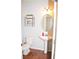 Small bathroom with pedestal sink and oval mirror at 532 Oakside Pl, Acworth, GA 30102