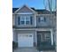 Gray townhome with white garage door and stone accents at 532 Oakside Pl, Acworth, GA 30102