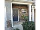 Townhome's front entry with stone facade and welcome decor at 532 Oakside Pl, Acworth, GA 30102