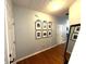 Hallway with hardwood floors and framed photos at 532 Oakside Pl, Acworth, GA 30102