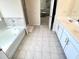 Bathroom featuring a garden tub and double vanity at 799 Blue Juniper Cir, Loganville, GA 30052