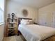 Bright bedroom with a queen bed, decorative shelving, and an adjacent bathroom at 799 Blue Juniper Cir, Loganville, GA 30052