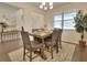 Bright dining room with a wooden table, chairs, and a chandelier at 799 Blue Juniper Cir, Loganville, GA 30052