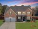A charming two-story home with a beautiful stone and brick facade at 799 Blue Juniper Cir, Loganville, GA 30052