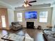 Spacious living room with hardwood floors, fireplace, and comfortable seating at 799 Blue Juniper Cir, Loganville, GA 30052