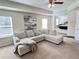 Relaxing living room with sectional sofa, view into main bedroom, and ceiling fan at 799 Blue Juniper Cir, Loganville, GA 30052