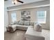 Relaxing living room featuring a large sectional sofa, ceiling fan, and neutral decor at 799 Blue Juniper Cir, Loganville, GA 30052