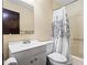 Clean bathroom with a shower/tub combo, vanity, and a white toilet at 812 Bartow Ct, Riverdale, GA 30274