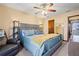 Main bedroom with king bed, ceiling fan, and full-length mirror at 812 Bartow Ct, Riverdale, GA 30274