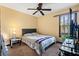 Cozy bedroom with a double bed, ceiling fan, and window with natural light at 812 Bartow Ct, Riverdale, GA 30274