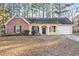 Brick and yellow sided ranch home with attached garage and screened porch at 812 Bartow Ct, Riverdale, GA 30274