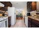 Open kitchen with dark cabinets and view of dining area at 812 Bartow Ct, Riverdale, GA 30274