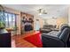 Living room with stone fireplace, hardwood floors, and ample natural light at 812 Bartow Ct, Riverdale, GA 30274