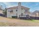 The back exterior shows a two-story home with a deck and a well-maintained, fenced-in yard at 1692 Branch Creek Cv, Lawrenceville, GA 30043