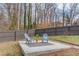 A patio with two chairs and a small plant provides a relaxing spot within a fenced backyard at 1692 Branch Creek Cv, Lawrenceville, GA 30043