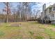 Large backyard showcasing a lawn, established trees, and a fenced perimeter at 1692 Branch Creek Cv, Lawrenceville, GA 30043