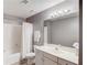 Cozy bathroom featuring a shower-tub combo, modern vanity, and neutral color scheme at 1692 Branch Creek Cv, Lawrenceville, GA 30043