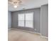 Carpeted bedroom featuring a ceiling fan and a large window for natural light at 1692 Branch Creek Cv, Lawrenceville, GA 30043