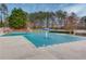 A view of the community pool with a light blue cover and umbrella in the middle at 1692 Branch Creek Cv, Lawrenceville, GA 30043