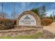 Stone entrance sign to the Highland Oaks community under a bright sky at 1692 Branch Creek Cv, Lawrenceville, GA 30043