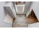 Foyer with hardwood floors, white door, and view of a dining room at 1692 Branch Creek Cv, Lawrenceville, GA 30043