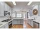 Bright kitchen featuring stainless appliances, white countertops, and grey cabinets at 1692 Branch Creek Cv, Lawrenceville, GA 30043