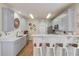 Kitchen bar with white cabinets, stainless appliances, and hardwood floors at 1692 Branch Creek Cv, Lawrenceville, GA 30043