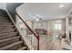 Inviting living room showcasing an open floor plan, hardwood floors, and staircase with wood railing at 1692 Branch Creek Cv, Lawrenceville, GA 30043