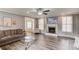 Cozy living room boasts hardwood floors, a fireplace, and a seamless layout connecting to other living spaces at 1692 Branch Creek Cv, Lawrenceville, GA 30043