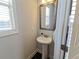 Small powder room with pedestal sink and mirror at 2452 Pearl Ridge Trce, Buford, GA 30519