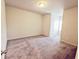 Spacious bedroom with neutral-toned carpeting and an exterior door at 2452 Pearl Ridge Trce, Buford, GA 30519