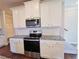 Modern kitchen with white cabinets and granite countertops at 2452 Pearl Ridge Trce, Buford, GA 30519