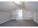 Lofted bonus room featuring neutral colored walls, carpet, and lighting at 3049 Flat Shoals Rd, Atlanta, GA 30349