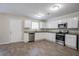 Well-lit kitchen with stainless steel appliances, white cabinets, and wood-look flooring at 3049 Flat Shoals Rd, Atlanta, GA 30349