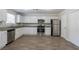 The kitchen features stainless steel appliances, white cabinets, and a stone-look counter at 3049 Flat Shoals Rd, Atlanta, GA 30349