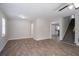 Open living area with wood-look floors, neutral paint, and views of the staircase at 3049 Flat Shoals Rd, Atlanta, GA 30349